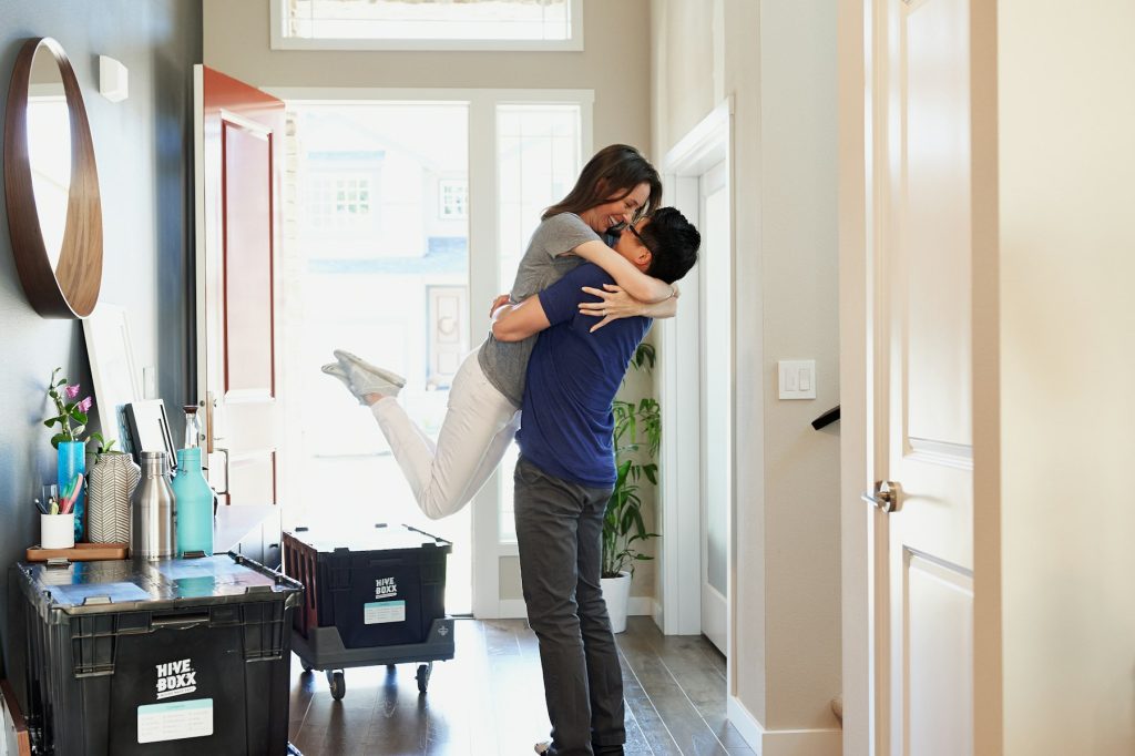Happy couple celebrating in their home
