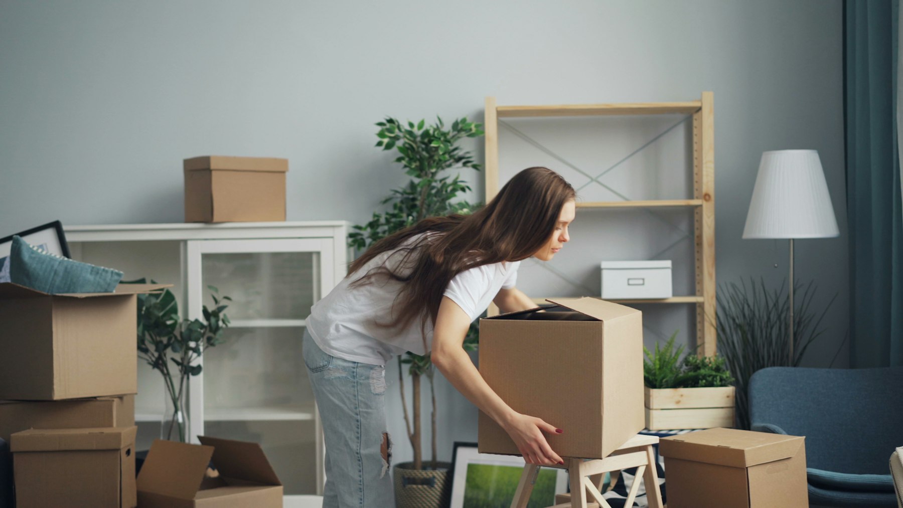 Homeowner packing moving boxes